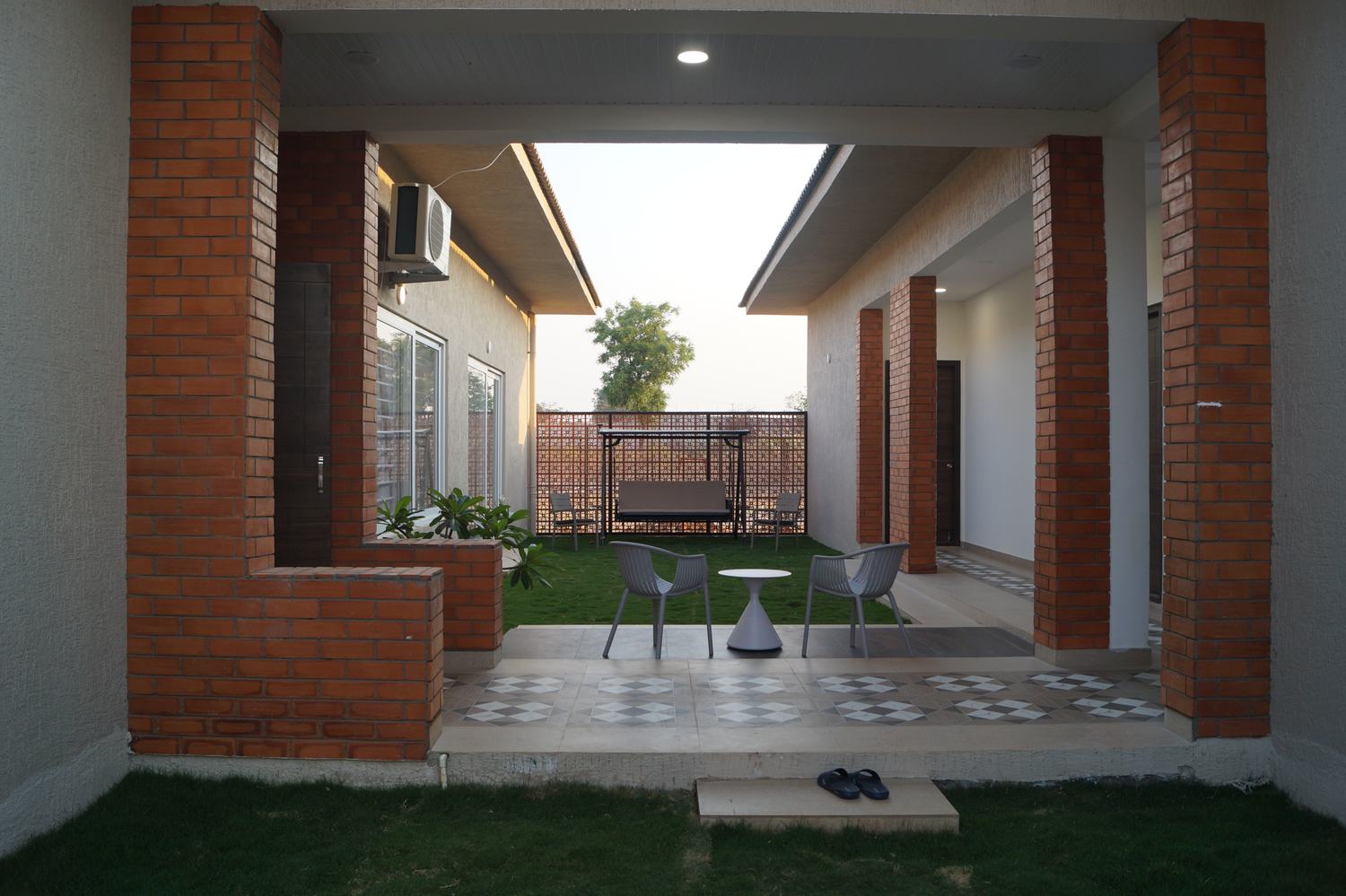Brick-column courtyard with lawn and outdoor seating